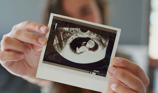 Excited Mom showing off baby’s ultrasound